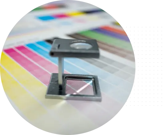 A magnifying glass placed on a color palette